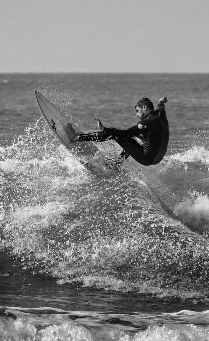Felipe Kautzmann surfing, grayscale portrait